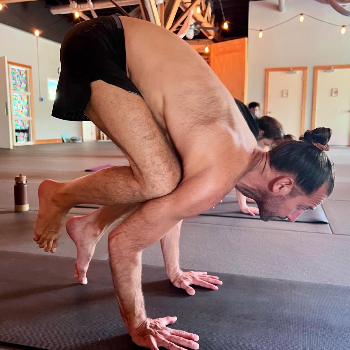 A student holding crow pose