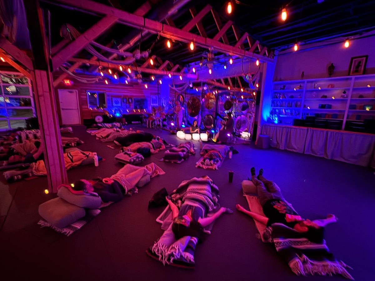 Students resting under blankets in low light